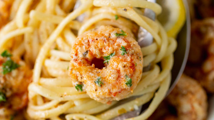 creamy cajun shrimp scampi over pasta is a flavor-packed, cheesy dream: try the easy recipe
