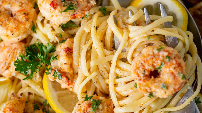 creamy cajun shrimp scampi over pasta is a flavor-packed, cheesy dream: try the easy recipe