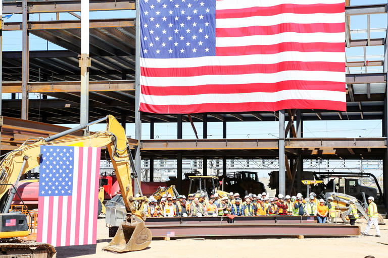 Workers wait to greet President Joe Biden as he arrives to make remarks on his Investing in America agenda at Intel's Ocotillo Campus in Chandler, Ariz. in March. (Alexandra Buxbaum / Sipa USA via AP Images )