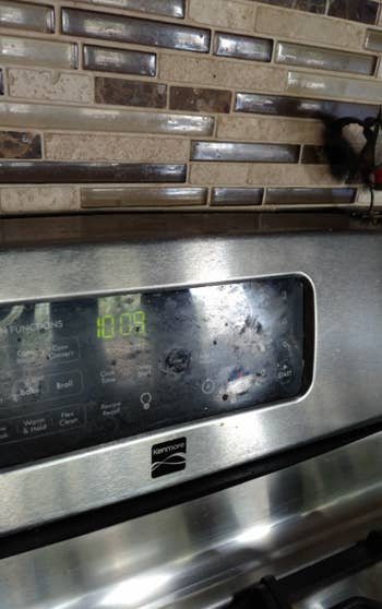 top of oven with screen and timer covered in fingerprints and grease