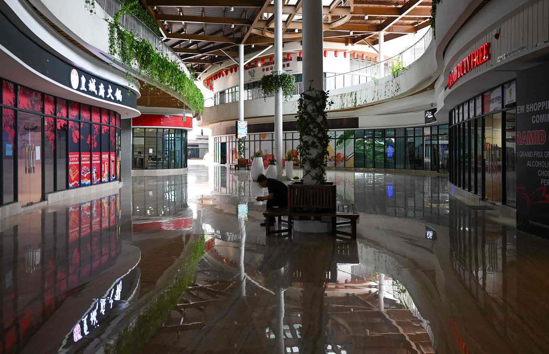 <p>In the deserted shopping mall, many of the stores and eateries are shuttered, some having never opened their doors in the first place. Forest City's duty-free status was intended to draw in punters, yet the anticipated crowds still haven't materialised. </p>  <p>The future of Forest City appears to be hanging in the balance. If Country Garden goes into liquidation, it's unclear who, if anyone, will take on the mantle of finishing the enormous project. Could this metropolis, once advertised as a "green living paradise," be reduced to a failed utopia? Only time will tell. </p>