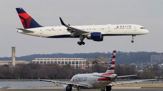 An American Airlines aircraft taxis as a Delta Air Lines aircraft lands at Reagan National Airport in Arlington, Virginia, U.S. REUTERS/Joshua Roberts/File Photo