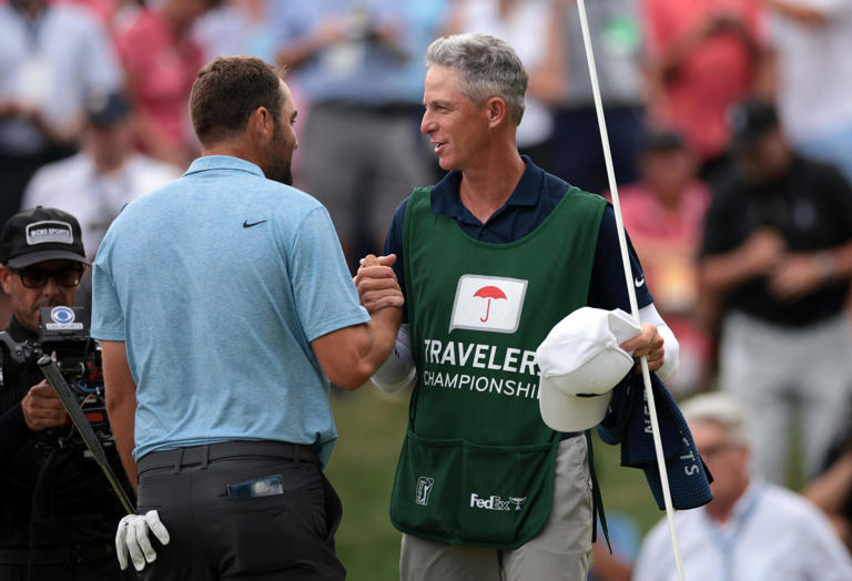 Scottie Scheffler of the United States reacts to his winning putt on the 18th green, the first playoff hole, with caddie Ted Scott during the final round of the Travelers Championship at TPC River Highlands on June 23, 2024 in Cromwell, Connecticut. (Photo by James Gilbert/Getty Images)