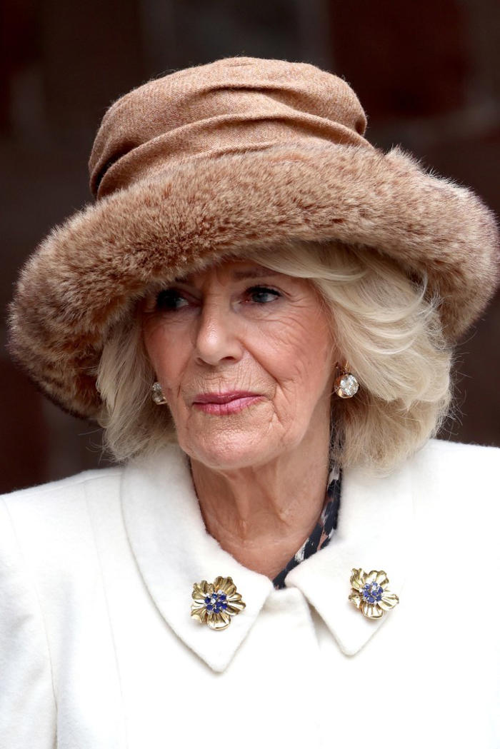 queen camilla wearing queen elizabeth ii's jewelry: brooches, sapphire and diamond tiara, coronation day necklace and more