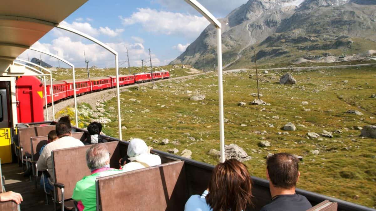 <p>The Bernina Express offers a picturesque train trip from Chur, Switzerland, to Tirano, Italy. During this journey, you’ll traverse 55 tunnels and cross over 195 bridges, including the UNESCO World Heritage Site of Rhaetian Railway. The route showcases stunning sights like glaciers, lakes, and numerous mountains.</p><p>The train ride duration ranges from 4 hours to 4 hours and 30 minutes. The Bernina Express, with its spacious panoramic windows, provides breathtaking views of the diverse landscapes along the way. While the standard ride is comfortable, consider upgrading to First Class for an extra touch of luxury.</p>