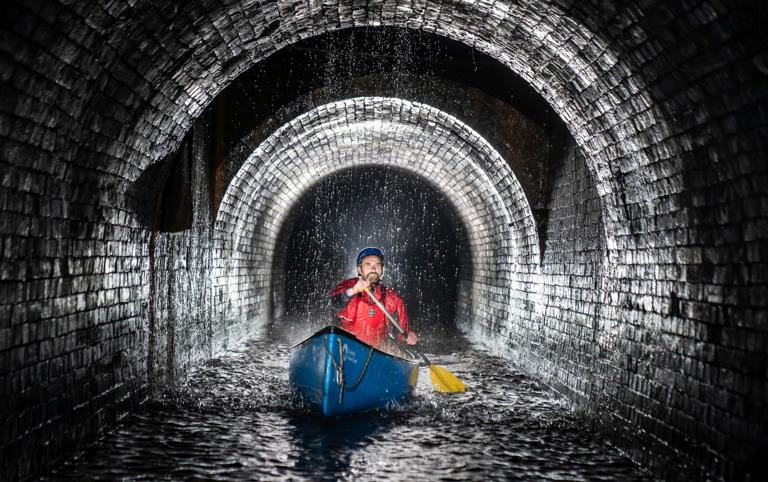 A Canal & River Trust team leader canoes through Standedge Tunnel on the Huddersfield Narrow Canal