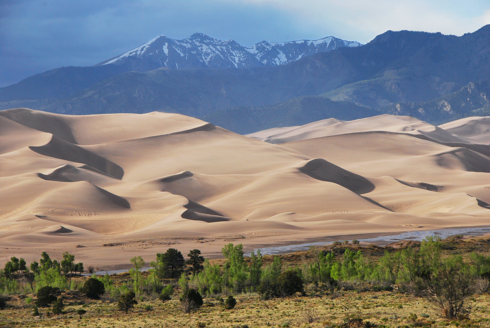 <p>Great Sand Dunes boasts the tallest sand dunes in North America, perfect for sandboarding and sledding. The park’s diverse landscape includes mountains, wetlands, and forests. Hiking to the top of the dunes offers panoramic views of the surrounding area. Medano Creek provides a refreshing spot for splashing and picnicking in the summer.</p>
