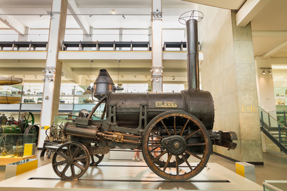 <p>Stephenson’s Rocket, designed by George Stephenson in 1829, was a pioneering steam locomotive that set the standard for future rail engines. It was the first to bring together several innovations such as a multi-tube boiler, which significantly increased steam pressure and efficiency, and direct drive wheels. The Rocket’s successful performance at the Rainhill Trials demonstrated the viability of steam-powered locomotives for passenger and freight transport, revolutionizing the early rail industry.</p>