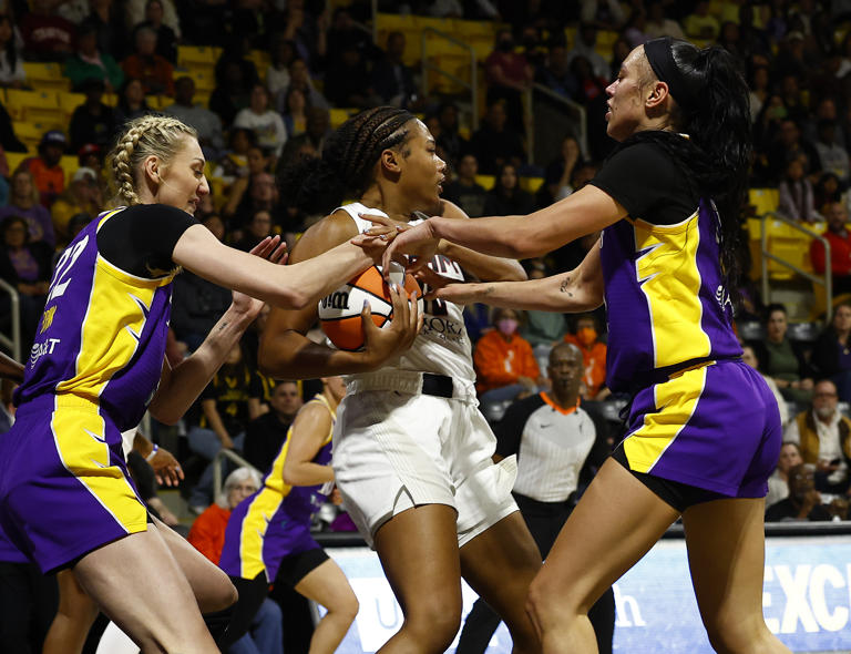 LONG BEACH, CALIFORNIA - MAY 15: Naz Hillmon #0 of the Atlanta Dream controls the ball against Cameron Brink #22 and Dearica Hamby #5 of the Los Angeles Sparks in the first half at Walter Pyramid on May 15, 2024 in Long Beach, California. USA Basketball has named Cameron Brink's replacement for the Paris 2024 Olympics.