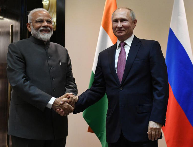 FILE PHOTO: Russian President Vladimir Putin shakes hands with Indian Prime Minister Narendra Modi before their meeting on the sidelines of the Shanghai Cooperation Organisation (SCO) summit in Bishkek, Kyrgyzstan June 13, 2019. Sputnik/Grigory Sysoyev/Kremlin via REUTERS/File Photo