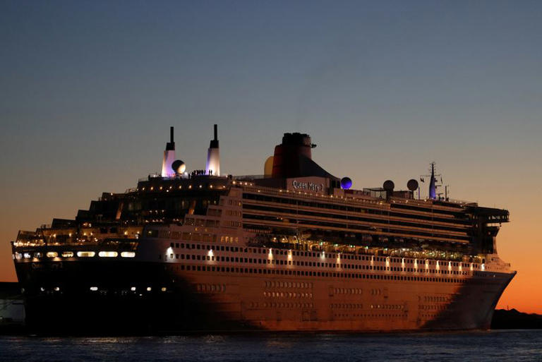 FILE PHOTO: The Queen Mary 2 cruise ship by Cunard Line, owned by Carnival Corporation & plc. is seen docked at Brooklyn Cruise Terminal in Brooklyn, New York City, U.S., December 20, 2021. REUTERS/Andrew Kelly/File Photo