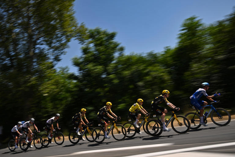 Jumbo-Visma's Danish rider Jonas Vingegaard wearing the overall leader's yellow jersey (3rd R) cycles during the 18th stage of the 110th edition of the Tour de France cycling race in the French Alps on July 20, 2023. (Photo by Marco BERTORELLO / AFP)