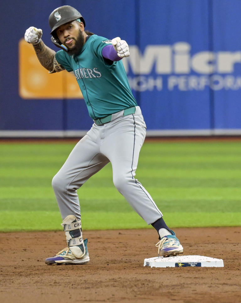 Seattle Mariners shortstop J.P. Crawford gestures toward the Martiners' dugout after reaching second base with a double off Tampa Bay Rays starter Ryan Pepiot during the third inning of a baseball game Wednesday, June 26, 2024, in St. Petersburg, Fla. (AP Photo/Steve Nesius)