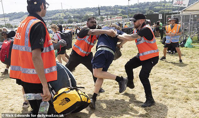 Moment Glastonbury guards tackle man who tried to gatecrash festival