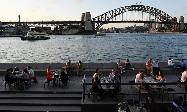 People dine-in at a bar by the harbor in Sydney, Australia, Oct. 22, 2021. Photo by Reuters