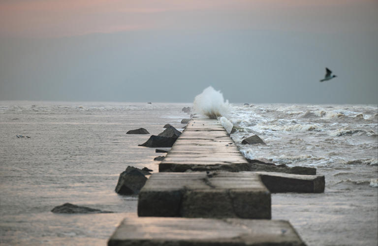 Water breaks against Galveston Island’s century-old seawall. The barrier was an engineering marvel in the early 1900s, but the island needs more protection today.