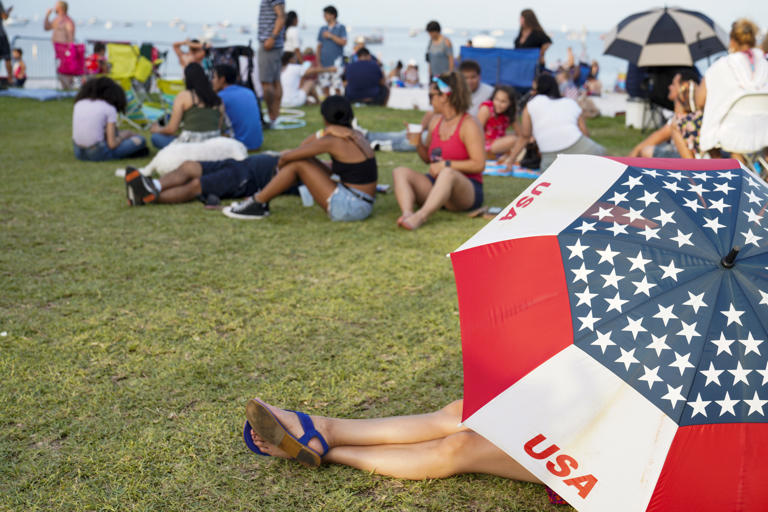 People enjoy the festivities from Spa Beach at the St. Pete Pier during Fourth of July celebrations in St. Petersburg.
