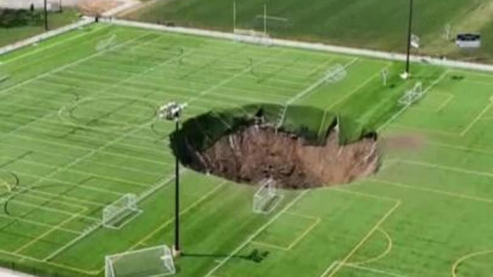 huge sinkhole '100ft deep' opens up in middle of football pitch