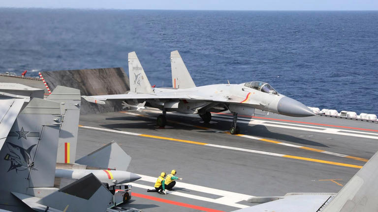 A Chinese J-15 fighter jet prepares to take off from the Shandong aircraft carrier during a military exercise around Taiwan on April 9, 2023. (An Ni/Xinhua via AP)