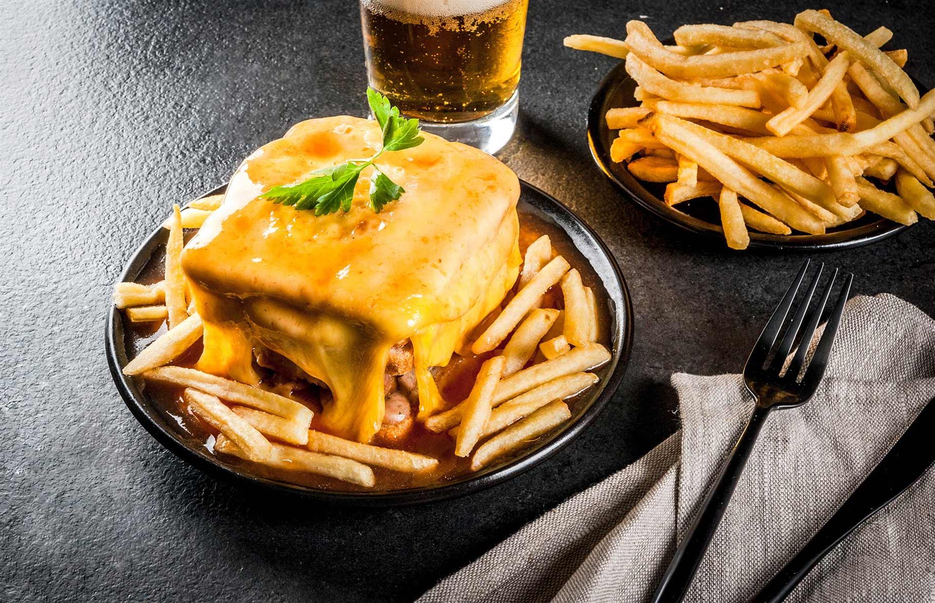 <p>The francesinha is a hearty and indulgent sandwich that has evolved into a national gastronomic treasure. Its history dates back to the 1960s when a French-inspired croque-monsieur met Portuguese ingredients, resulting in the birth of this dish. Translated as 'little Frenchie' in English, the francesinha has become a culinary sensation not only in Porto but throughout Portugal. Its popularity has transcended regional boundaries, earning it a place on menus across the country as a beloved comfort food.</p>