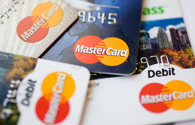 MasterCard logos appear on credit and debit cards arranged f