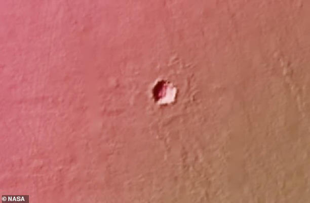 Scientists are unsure how deep the holes on Mars go (pictured). They believe they formed during after a volcanic explosion caused lava tubes to form