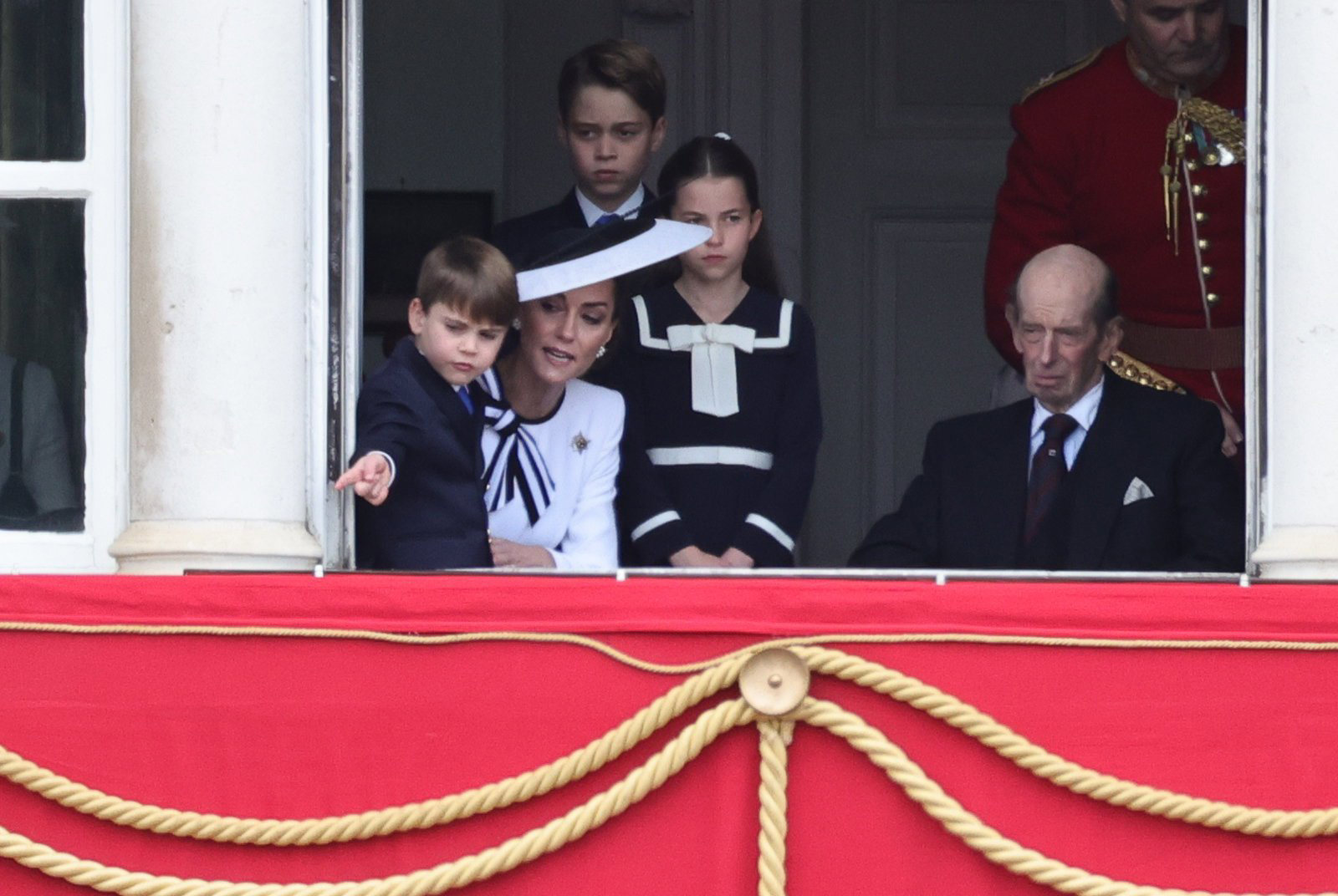 Smiling Kate waves to crowds with Louis, Charlotte and George