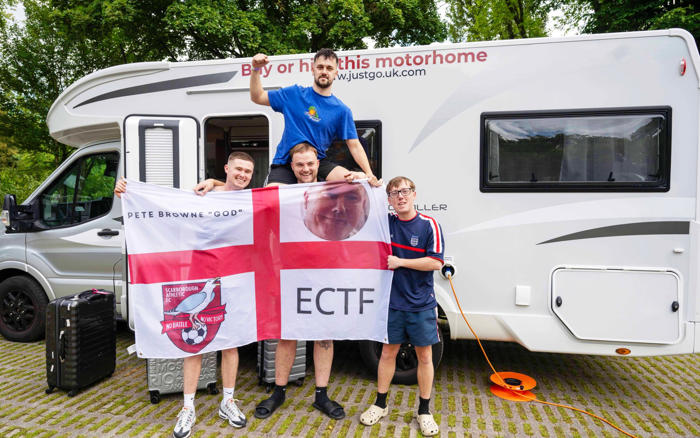 three in the bed: england fans find asylum seekers hiding in camper van