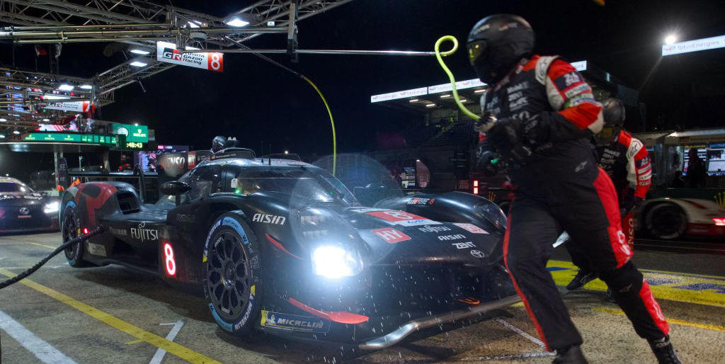 halfway through the 24 hours of le mans, toyota leads porsche under a safety car as rain continues