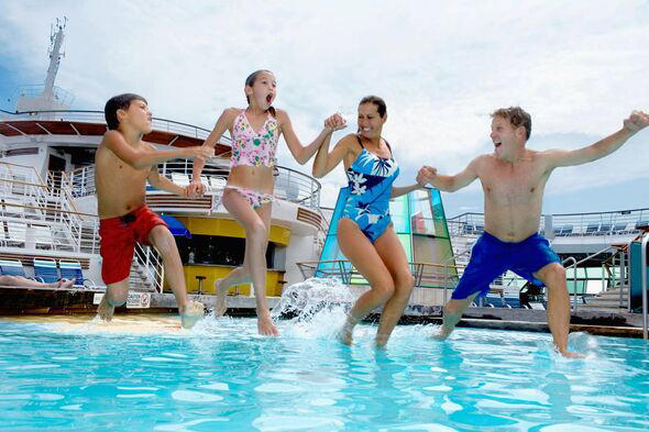 A family of four jump into a pool on a cruise ship