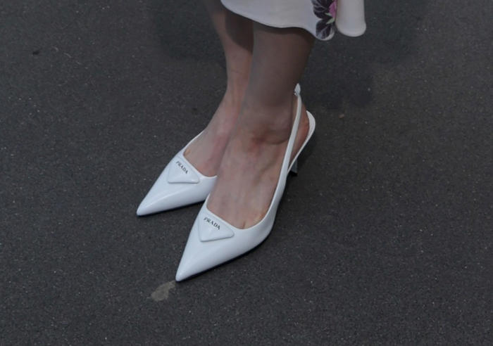 twice's sana re-wears her favorite white slingback heels at prada's summer 2025 show during milan fashion week