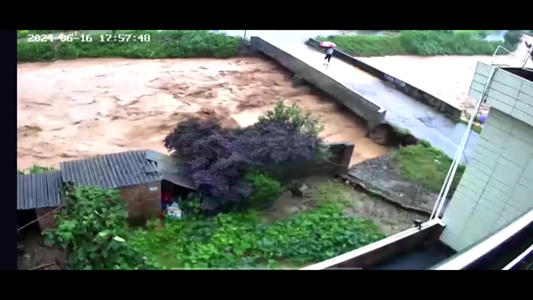Person narrowly escapes breaking bridge as heavy rains, floods hit China