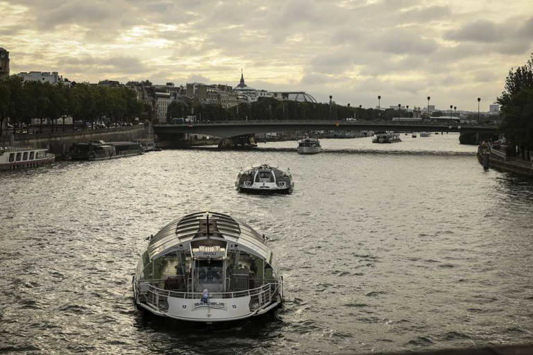Dozens of boats cruise the Seine river in a rehearsal for the Paris Olympics' opening ceremony