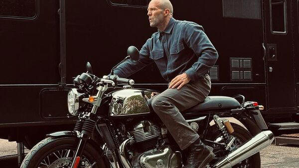 hollywood actor, jason statham poses with royal enfield continental gt 650