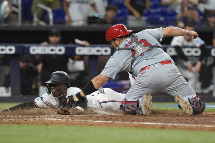 winn's homer in 12th, carlson's throw lead cardinals over marlins for 1st winning record since april