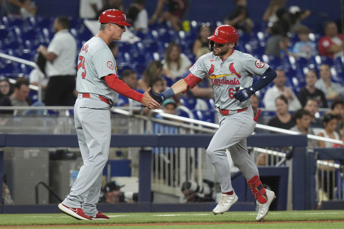 winn's homer in 12th, carlson's throw lead cardinals over marlins for 1st winning record since april