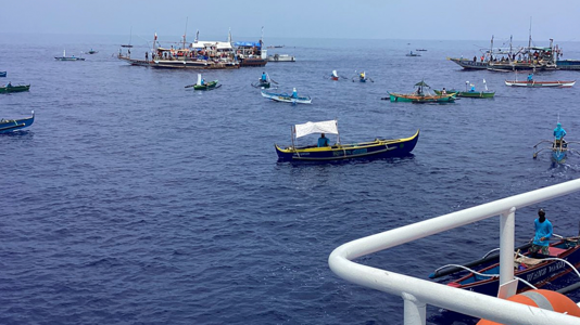 Fishing boats carrying activists and volunteers belonging to a nongovernment coalition called Atin Ito, Tagalog for This is Ours, pass by waters off Palauig Point, Zambales province, northwestern Philippines as they head toward Scarborough Shoal on May 15, 2024. AP Images