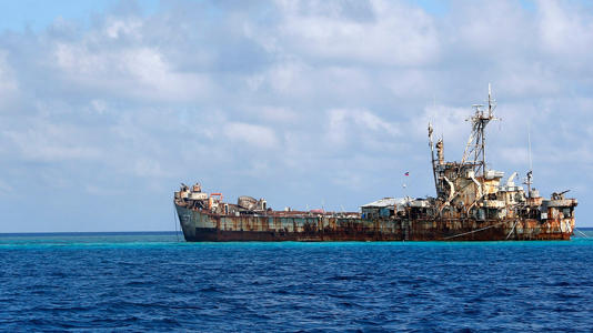 A Chinese Coast Guard vessel patrols near the BRP Sierra Madre, a marooned transport ship that Philippine marines live on as a military outpost, in the disputed Second Thomas Shoal, part of the Spratly Islands in the South China Sea, March 30, 2014. Reuters