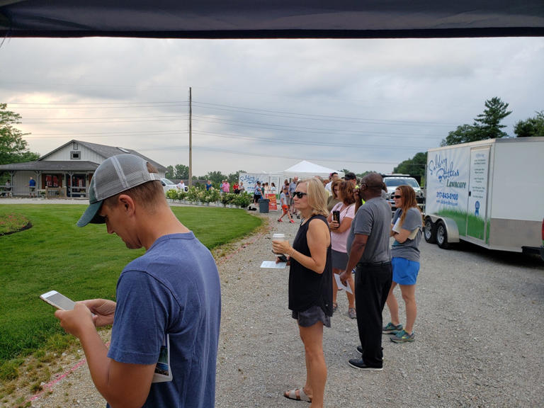 People wait in line for their turn to buy fresh Georgia peaches from The Peach Truck Tour in 2019 at the Salsbery Brothers Landscaping stop in Carmel.