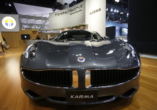 FILE - Fisker Automotive's Fisker Karma, a sports luxury plug-in hybrid car, is displayed at the 2010 Los Angeles Auto Show in Los Angeles, Cal, Nov. 18, 2010. Electric vehicle maker Fisker has filed for Chapter 11 bankruptcy protection in a period when even the top manufactures in the industry a struggling. Its operating subsidiary, Fisker Group Inc., said in its filing that its estimated assets were between $500 million and $1 billion. (AP Photo/Damian Dovarganes, File)