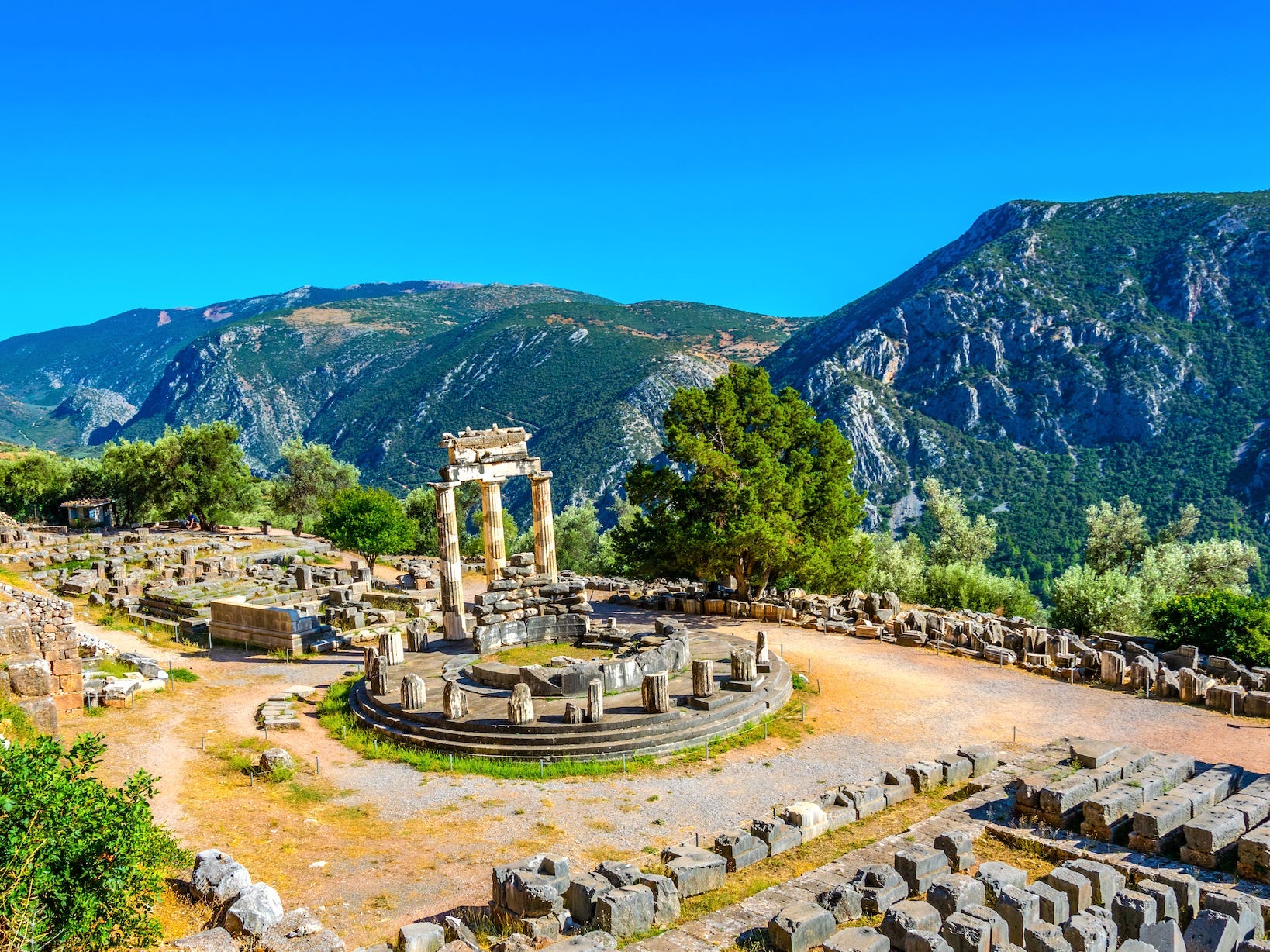 <p>Ancient Greeks believed that Delphi was the "navel of the world." The myth goes that Zeus released one eagle from the east and one from the west and the birds met in the middle at Delphi, where the famous oracle was built. </p><p>In addition to being an incredible archaeological site, Delphi also has a stunning natural backdrop. My mother said she still remembers the sweeping views of the valleys and the lovely olive trees in addition to the incredible ancient ruins. </p><p>"I loved visiting Delphi because of its history, but also because of the beautiful natural surroundings," she added. </p>