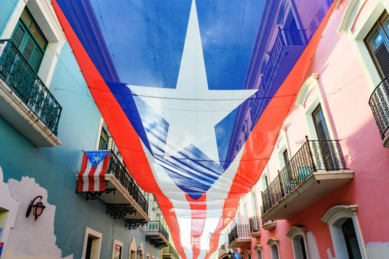 Puerto Rican flag waving over street in Old San Juan, Puerto Rico