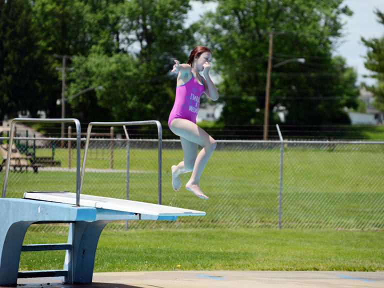 A swimmer jumps off the diving board at the Frazeysburg Pool in this Times Recorder file photo