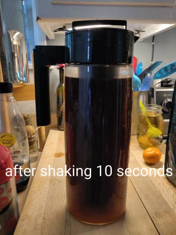 the cold brew maker after it's been shaken for 10 seconds and the water is now dark brown