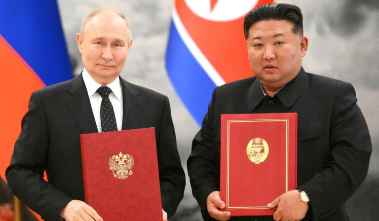 Russia's president Vladimir Putin and North Korea's leader Kim Jong-Un pose for a photo during a signing ceremony following bilateral talks in Pyongyang, North Korea, June 19, 2024.