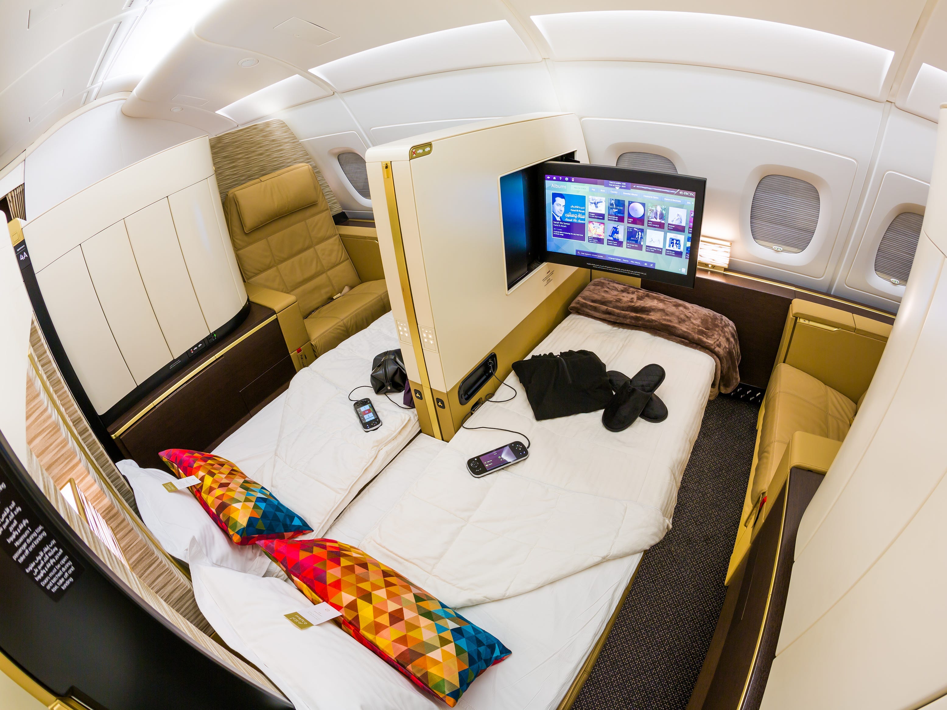 <p>UAE-based <a href="https://www.businessinsider.com/etihad-airways-first-class-apartment-family-travel-points-worth-it-2024-5">Etihad Airways' private first-class rooms</a> are similarly luxurious, with a separate chair and couch to create that "apartment"-like feel.</p><p>The couch flips into a bed, and the top half can open to an adjoining pod.</p>