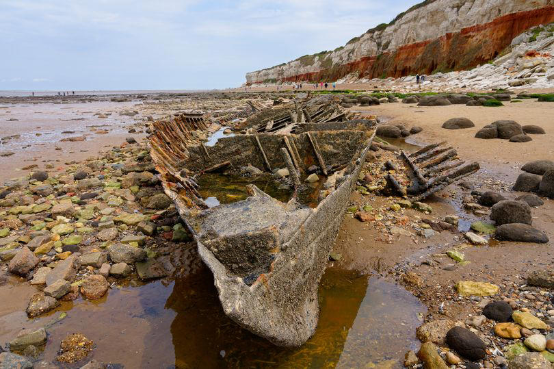 uk beach with unique cliffs landscape and ww2 shipwreck