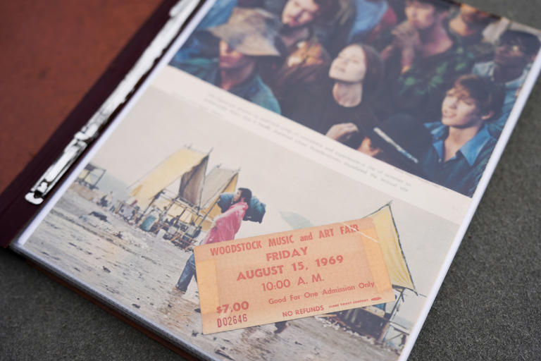 El boleto para la Feria de Arte y Música de Woodstock de Ellen Shelburne se muestra en un álbum de fotos, el viernes 14 de junio de 2024, en Bethel, Nueva York. (Foto AP/Julia Nikhinson)