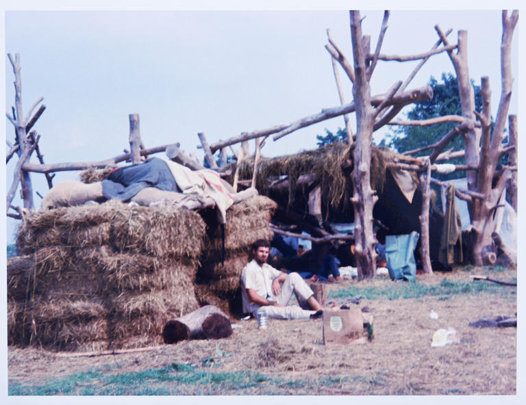 Esta fotografía de agosto de 1969 muestra a los asistentes a la Feria de Arte y Música de Woodstock acampando con refugios hechos con fardos de heno en los terrenos de Bethel, Nueva York. El Centro para las Artes Bethel Woods, la organización sin fines de lucro que administra el sitio, ahora presenta nuevas instalaciones para acampar con lujo. (David Shelburne vía AP)