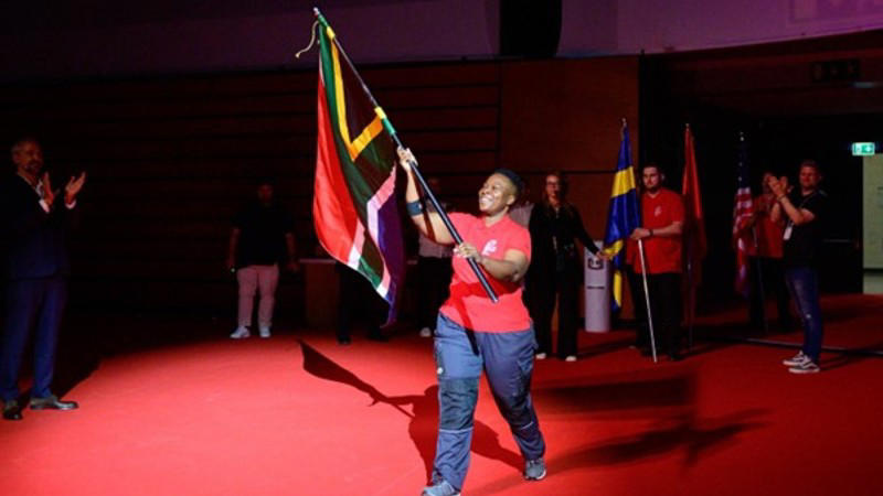 woman carries sa flag high and wins at a top global competition